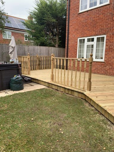 Beautiful wooden decking featuring a decorative balustrade, ideal for outdoor entertainment