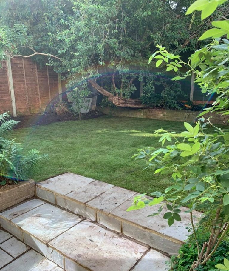 Beautiful Indian sandstone steps leading to fresh, newly laid turf