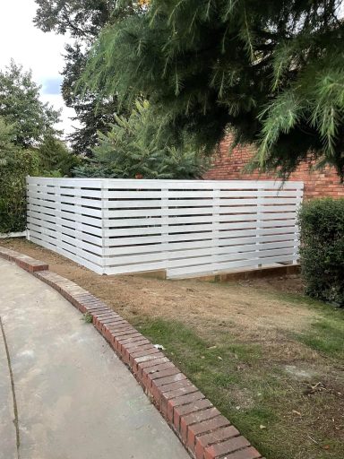 Custom made Venetian-style fence that blends seamlessly with the surrounding street aesthetics