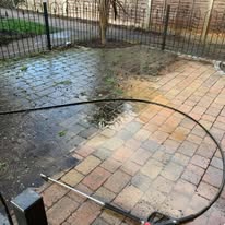 Pressure washed driveway showing a clear contrast between clean and dirty surfaces for effective cleaning demonstration