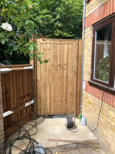 Closed board gate designed for side entrance, ensuring privacy and security in the garden